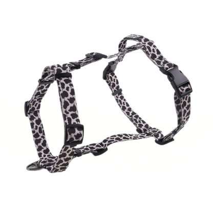 cow print dog harness on a white background